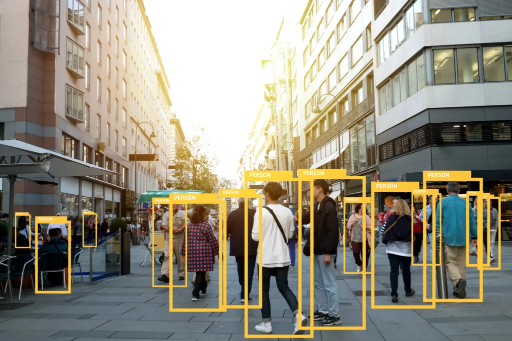 A group of individuals on a city street with the label of "person" above each one