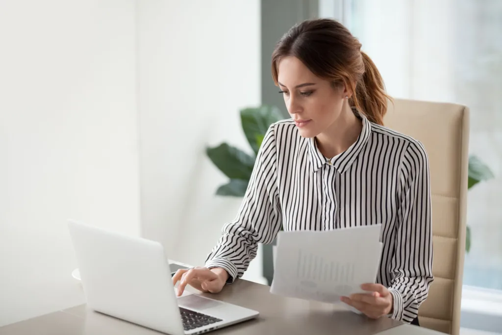 A woman working on a laptop.