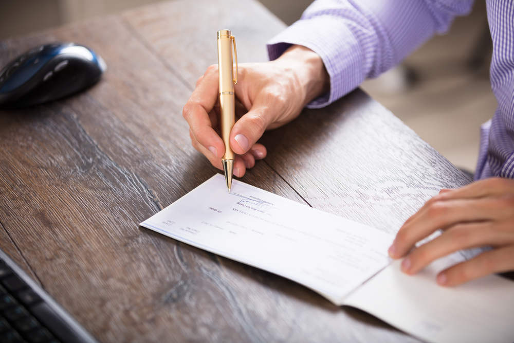 A person signing a check