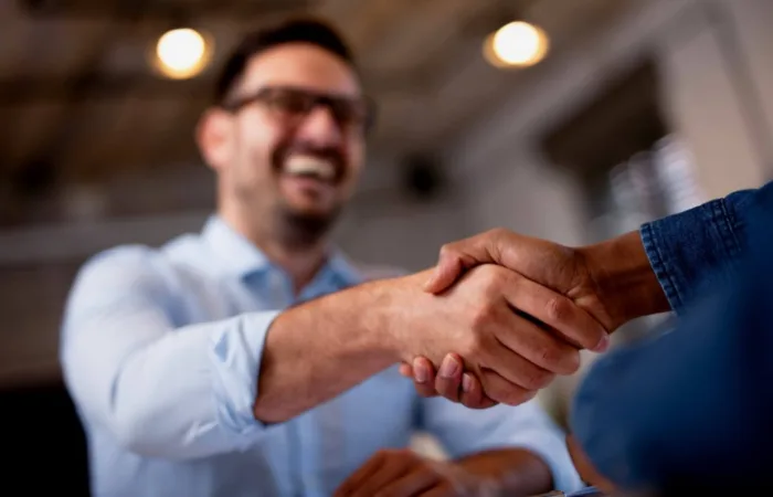 A close up of two people shaking hands