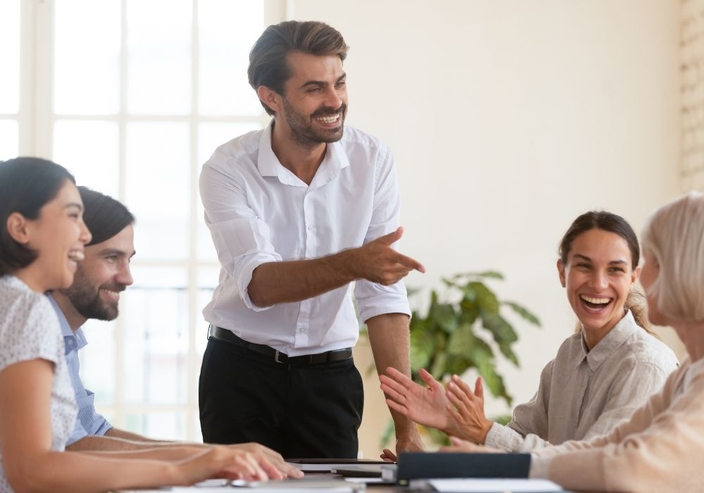 Group of professionals laughing in a meeting