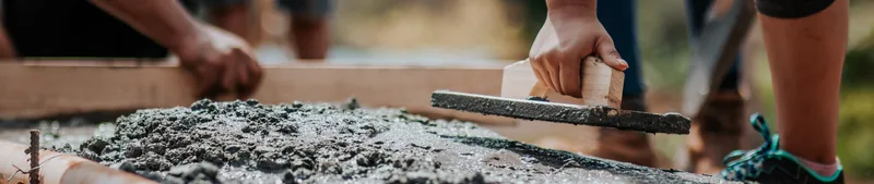 Workers leveling freshly poured concrete